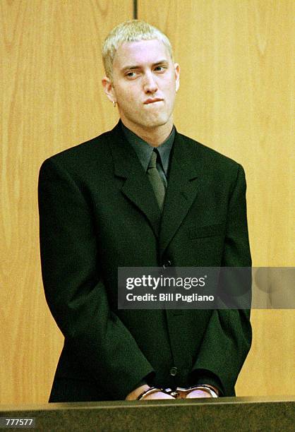 Rap artist Marshall Mathers III, a.k.a. Eminem, left, stands in handcuffs June 7, 2000 in the 37th district court in Warren, Michigan during his...