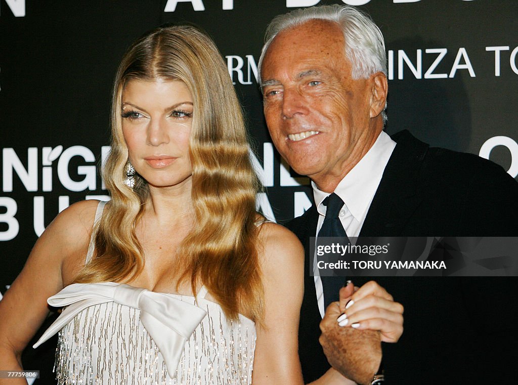 Italian designer Giorgio Armani (R) pose
