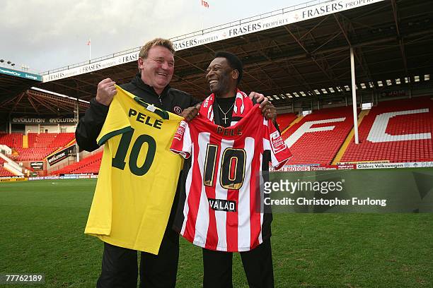 Former Brazilian national footballer Pele and former Sheffield United and England national footballer Tony Currie pose with Brazil and Sheffield...