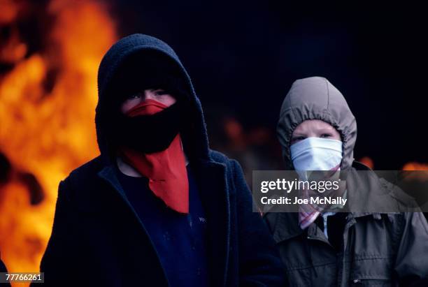 Two young boys pose in face masks in May of 1981 infront of a blazing fire in Northern Ireland. Bobby Sands, an active member of the Irish Republican...