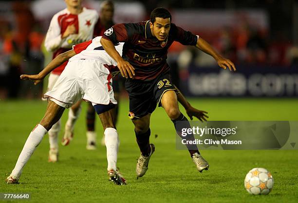 Theo Walcott of Arsenal holds off a challenge from Mickael Tavares of Slavia Prague during the UEFA Champions League Group H match between SK Slavia...