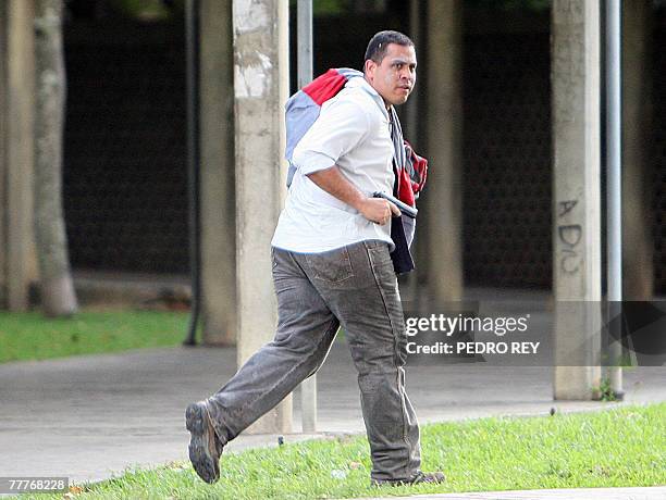 Young man holding a handgun runs during a shootout after a march toward Venezuela's Supreme Electoral Tribunal demanding the postponement of the...