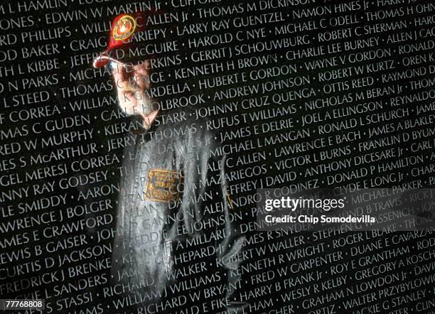 Vietnam veteran Lyle Hurley of Woodbridge, Virginia is reflected in the Vietnam Veterans Memorial during ceremonies to mark The Wall's 25th...