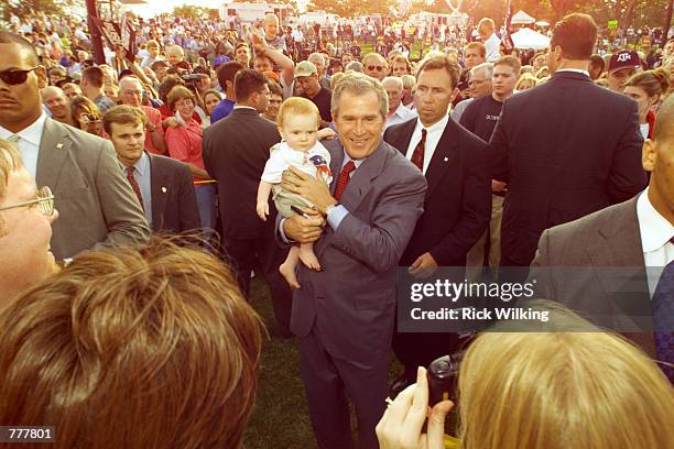 Texas Governor and Republican presidential candidate George W. Bush holds a baby at a campaign rally July 29, 2000 in Covington, Kentucky. Bush was...