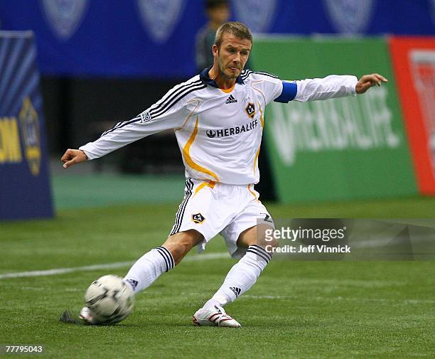 David Beckham of the Los Angeles Galaxy kicks the ball during their exhibition soccer match against the Vancouver Whitecaps at BC Place Stadium on...