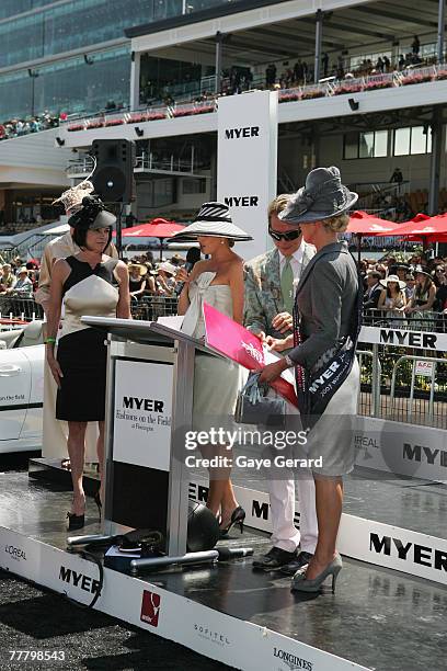 Stylist and fashion tv personality Carson Kressley stands beside winner of the Fashion On The Field best dressed award, Lorraine Cookson during the...