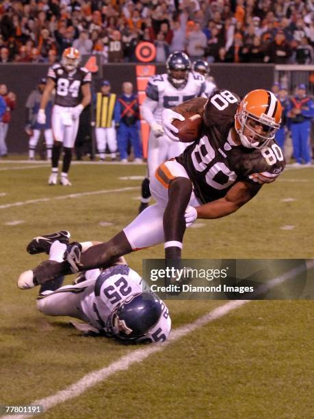 Tight end Kellen Winslow Jr. #80 of the Cleveland Browns hurdles defensive back Brian Russell of the Seattle Seahawks after catching a pass during a...