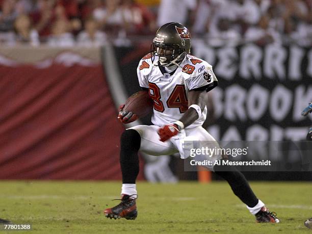Wide receiver Joey Galloway of the Tampa Bay Buccaneers rushes upfield with a pass against the Jacksonville Jaguars at Raymond James Stadium on...