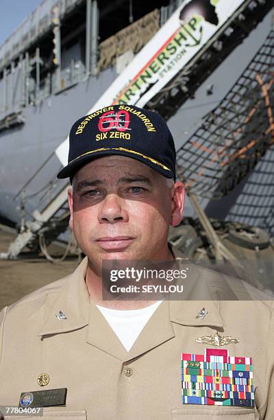 Captain and operation commander of the African Partnership Station American John B. Nowell poses 08 November 2007 in front of the gang-way of USS...