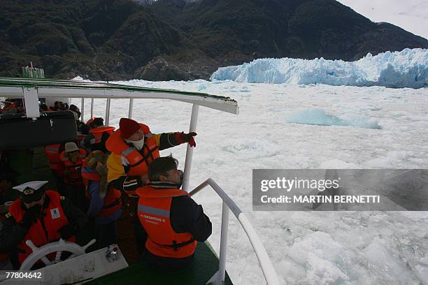 Tourists onboard the Skorpios ship admire the Northern Patagonian Ice Field, located in the Laguna San Rafael National Park, 1300 km south of...