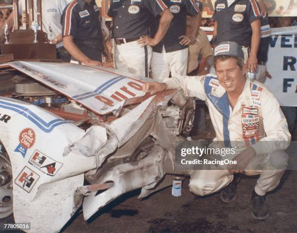 David Pearson driver of the Wood Brothers Mercury celebrates in victory lane after winning the 1976 Winston Cup Daytona 500 at the Daytona...