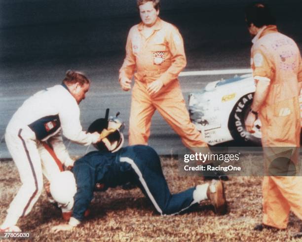 Cale Yarborough in the white hits Bobby Allison with his helmet after the two crashed during the last lap of the 1979 Winston Cup Daytona 500 at the...