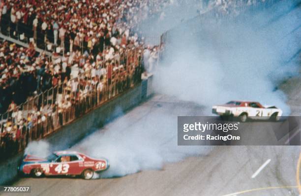 David Pearson driver of the Wood Brothers Mercury and Richard Petty driver of the STP Dodge crash during the1976 Winston Cup Daytona 500 at the...