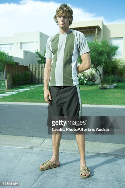 young man standing in residential neighborhood, full length portrait - skinny blonde stock pictures, royalty-free photos & images