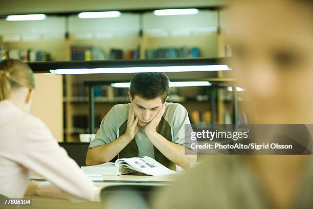 students studying in library - college student holding books stock pictures, royalty-free photos & images