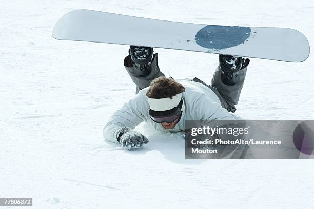 young snowboarder fallen on the ground, full length - northern european descent ストックフォトと画像