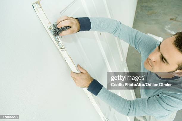 man scouring hinge on door, high angle view - scouring pad stock pictures, royalty-free photos & images