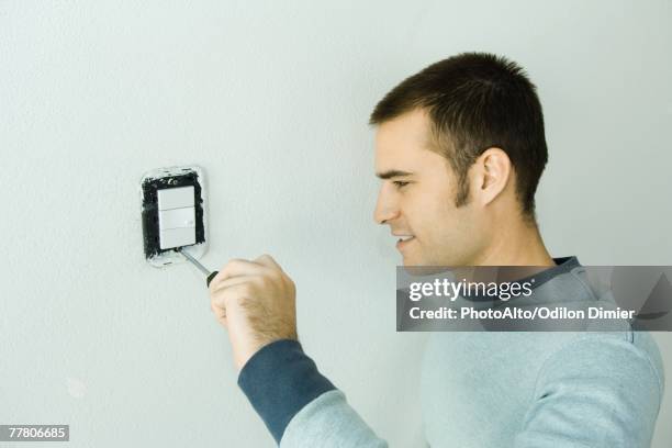 man removing light switch cover - light switch isolated stock pictures, royalty-free photos & images