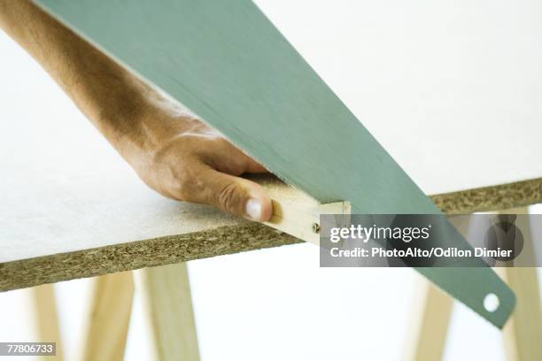 man sawing wood, cropped view of hand - cutting corners stock pictures, royalty-free photos & images