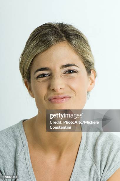 young woman making face, portrait - smirking stock pictures, royalty-free photos & images
