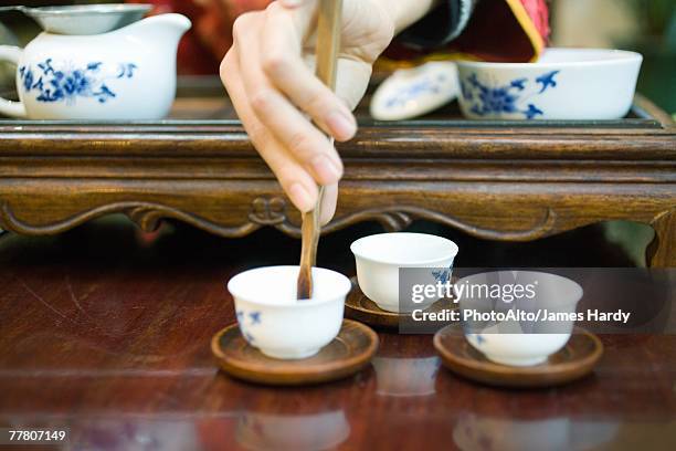 woman preparing tea, cropped view of hand - tea ceremony stock pictures, royalty-free photos & images