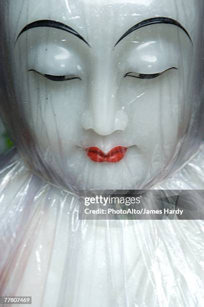 doll face under cellophane - chinese dolls stock pictures, royalty-free photos & images