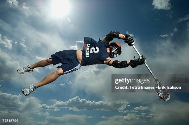 low angle view of jai-alai player jumping - lacrosse stock pictures, royalty-free photos & images