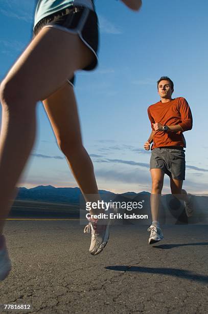 couple in athletic gear running - triathlon gear stock pictures, royalty-free photos & images