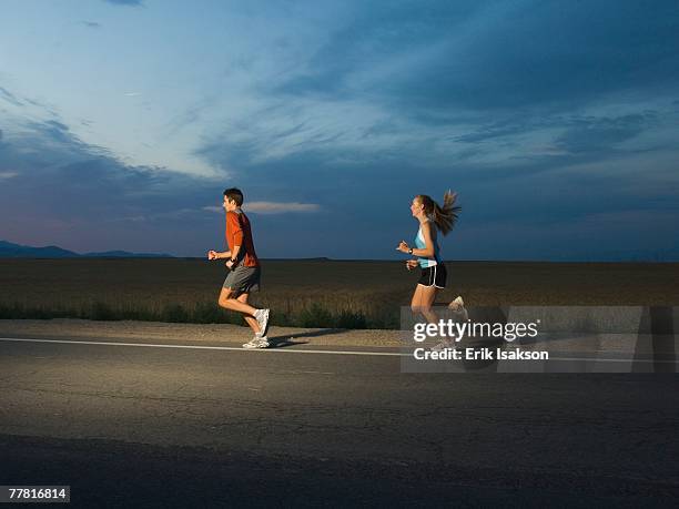 couple in athletic gear running - triathlon gear stock pictures, royalty-free photos & images