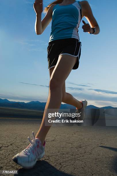 woman in athletic gear running - triathlon gear stock pictures, royalty-free photos & images