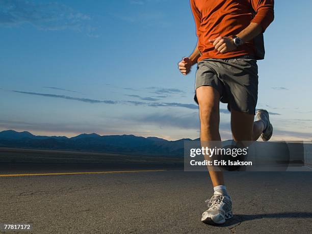 man in athletic gear running - triathlon gear stock pictures, royalty-free photos & images