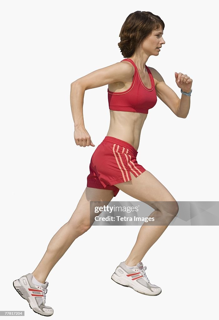 Woman jogging on urban sidewalk