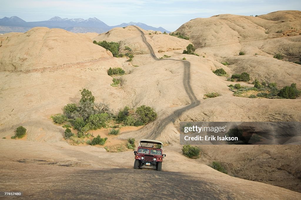 Off-road vehicle driving on rock formation