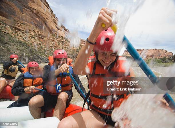 group of people paddling in raft - white water rafting stock pictures, royalty-free photos & images