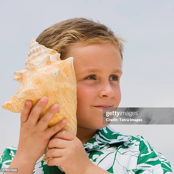 Boy And Shells 43 Boy Listening To Conch Shell Stock Photos, High-Res Pictures, and ...