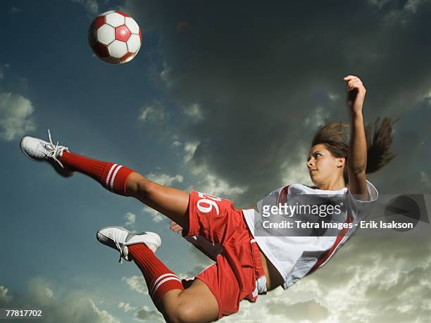 low angle view of soccer player jumping - female football player stock pictures, royalty-free photos & images