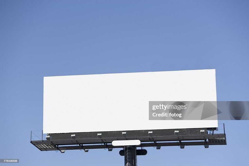 Blank billboard under blue sky