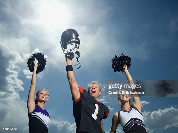 cheerleaders and football player cheering - dance team stock pictures, royalty-free photos & images