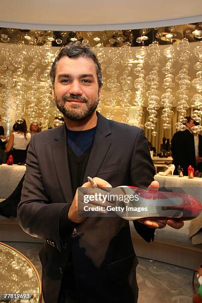 Edmudo Castillo autographs a shoe for customer Lea Turano at the party to celebrate Sergio Rossi shoe collection at Saks Fifth Ave November 8, 2007...