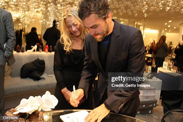 Edmundo Castillo signs an augtograph for Tracy Margolies at the party to celebrate Sergio Rossi shoe collection at Saks Fifth Ave November 8, 2007 in...