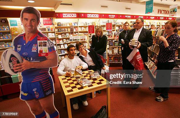 Former NRL rugby league player Andrew Johns takes pictures with a fan while signing copies of his new book, The Two of Me, at Dymocks book store on...