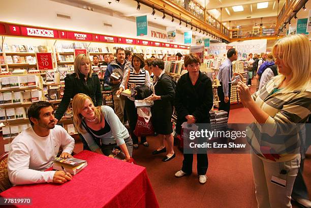 Former NRL rugby league player Andrew Johns takes pictures with a fan while signing copies of his new book, The Two of Me, at Dymocks book store on...