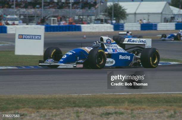 British racing driver Damon Hill drives the Rothmans Williams Renault Williams FW16 Renault RS6 3.5 V10 to finish in first place to win the 1994...