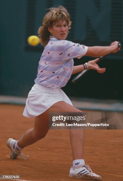 West German tennis player Steffi Graf pictured in action competing to progress to reach the final and win the Women's Singles tournament to become...