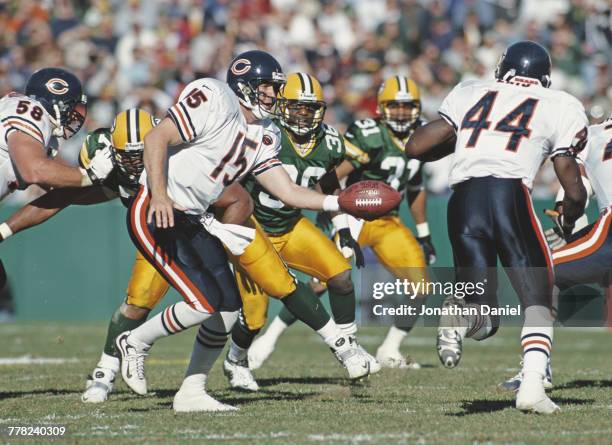 Jim Miller, Quarterback for the Chicago Bears hands the ball off to Running Back Curtis Enis during their National Football Conference Central game...