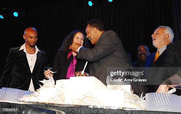 Founder and President of the Rainbow PUSH Coalition Reverend Jesse Jackson, Sr. Feeds birthday cake to Gina Belafonte at the VIP Cocktail Reception...