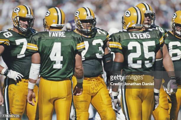 Quarterback Brett Favre and Running Back Dorsey Levens of the Green Bay Packers approach Aaron Taylor and Ross Verba of the offensive line during...