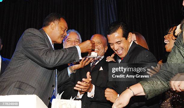 Founder and President of the Rainbow PUSH Coalition Reverend Jesse Jackson, Sr. Feeds birthday cake to actress Founder of Motown Records Berry Gordy...