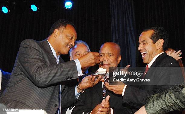 Founder and President of the Rainbow PUSH Coalition Reverend Jesse Jackson, Sr. Feeds birthday cake to actress Founder of Motown Records Berry Gordy...