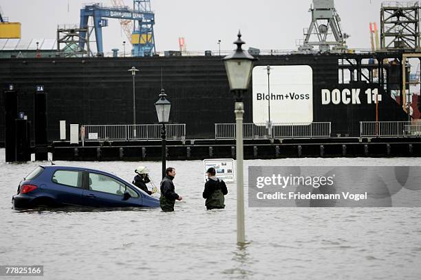 Firemen try to rescue a car at the Fischmarkt during the flood on November 9, 2007 in Hamburg, Germany.